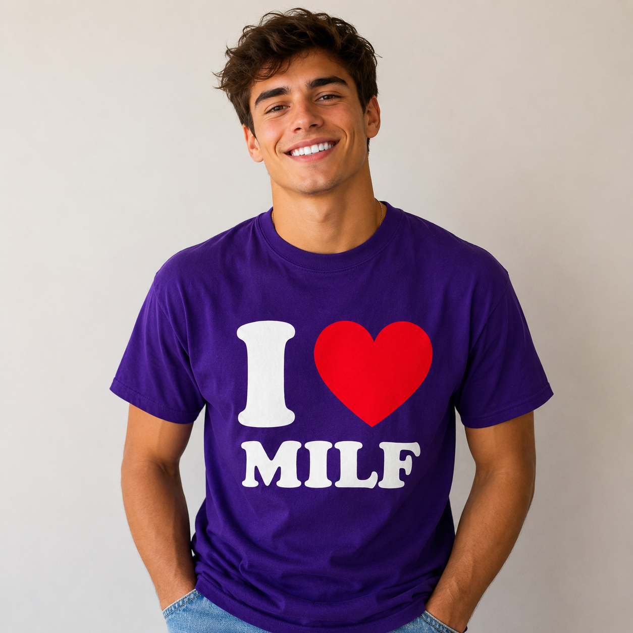 Man wearing a purple t-shirt with 'I ❤️ MILF' design on a plain background